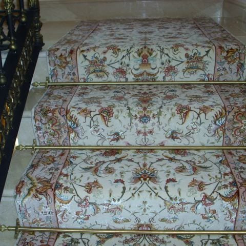 Dubai design stair rods in brass fitted on a wide floralstair runner