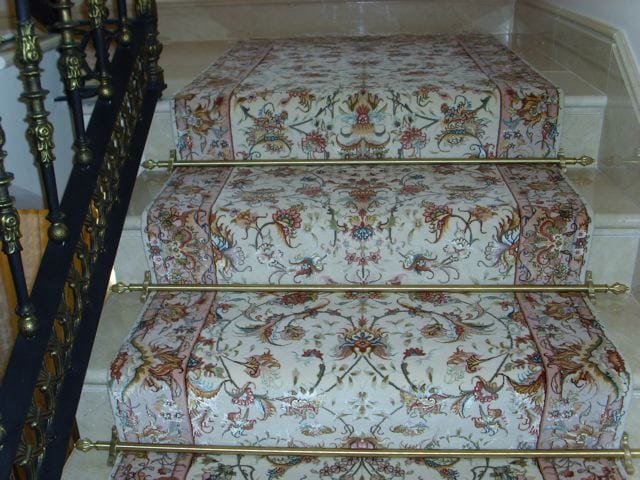 Dubai design stair rods in brass fitted on a wide floralstair runner