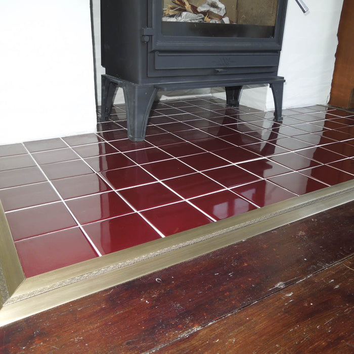 Posh door threshold edging red tiled hearth