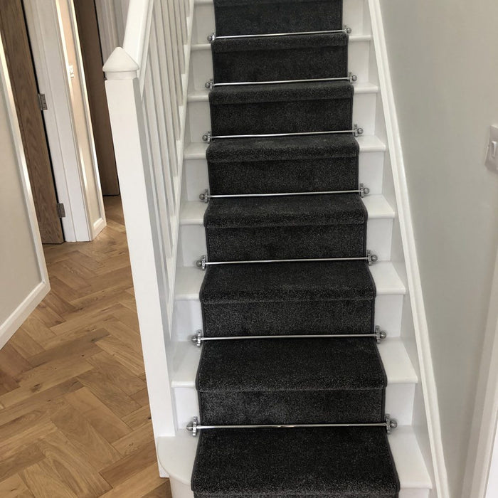 Polished chrome stair rods with sphere finials on teal stair runner