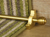 Sphere stair rods polished brass on green striped runner