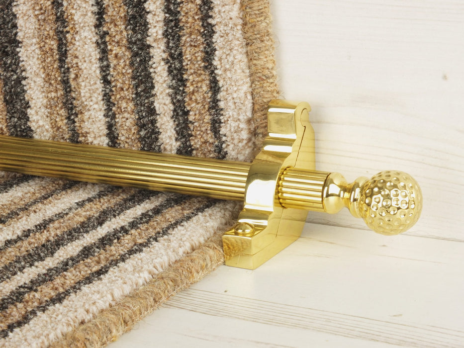 Extra large Dune stair rods on striped carpet