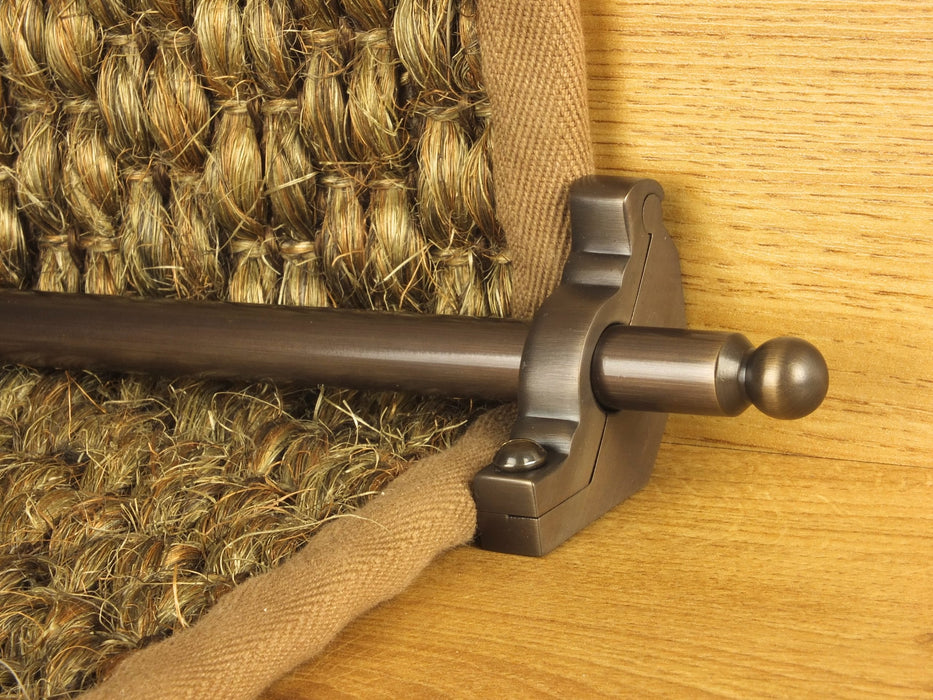 Windsor stair rod in antique bronze shown on seagrass runner