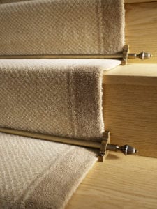 Dubai design of carpet rods in antique brass, fitted on beige carpet runner